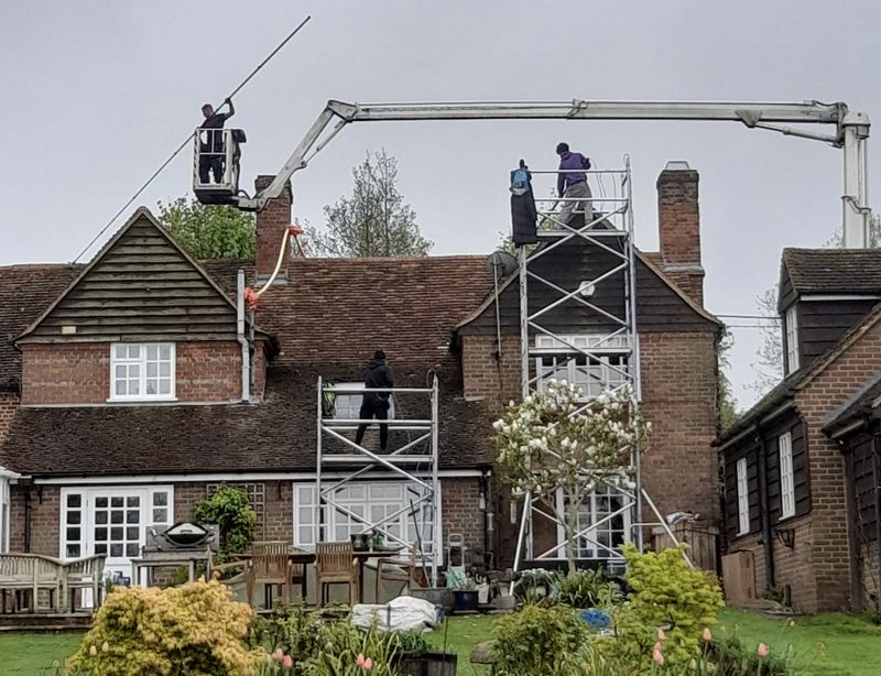 The Roof Moss Cleaners using cherry picker and scaffolding to clean roof safely and professionally in Witney, Oxfordshire